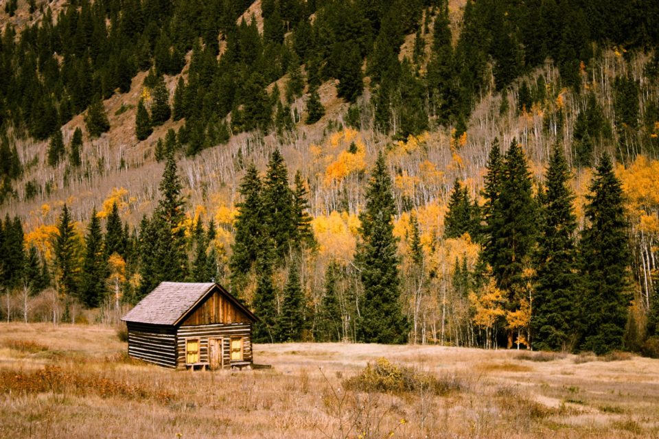 house in distance in front of a mountain